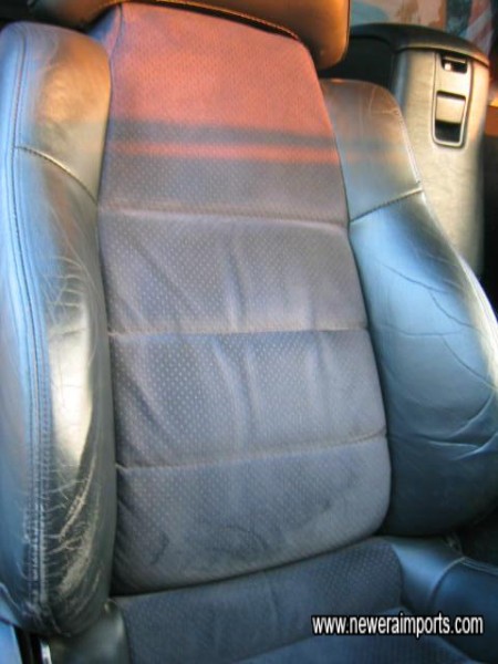 Driver's seat bolster is shiny from use over time. 